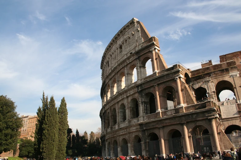 people walking and standing outside the ancient building