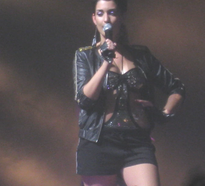 woman wearing black shorts and leather jacket singing