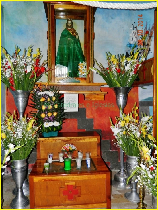 a altar topped with metal vases and flowers