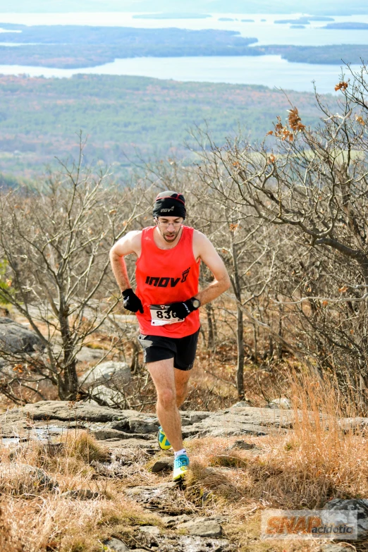 a man running on the side of a cliff