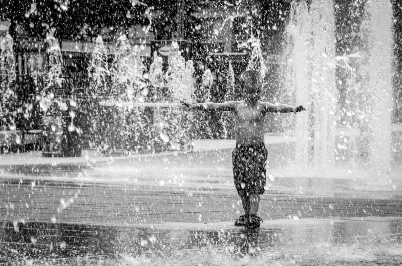 an open umbrella shows off a man standing in front of an outdoor fountain