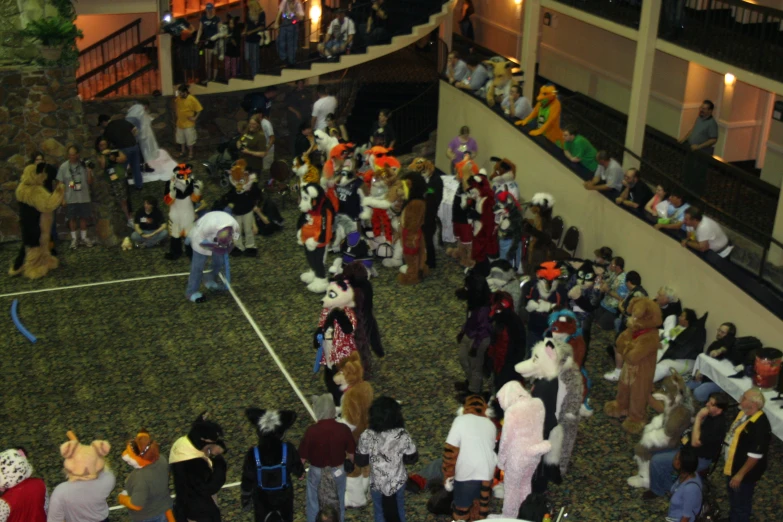 a group of people standing around inside of a building