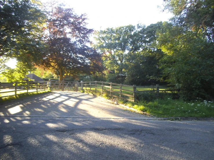 two wooden fences are along the sides of this road