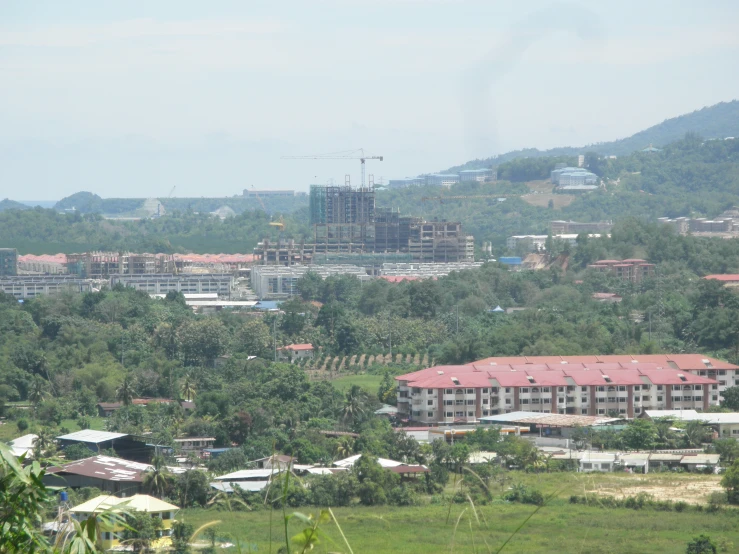 a view of buildings in a city with hills and trees