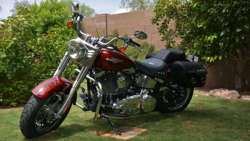 a red motorcycle is parked in the grass