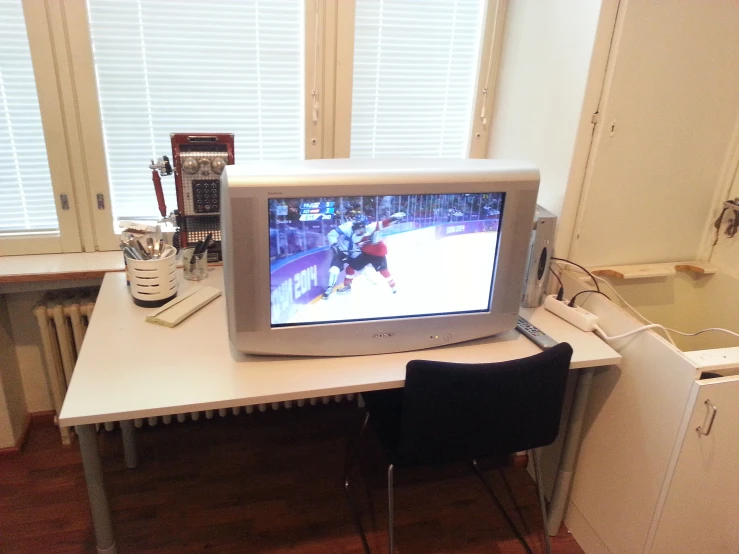 a computer monitor sitting on top of a desk