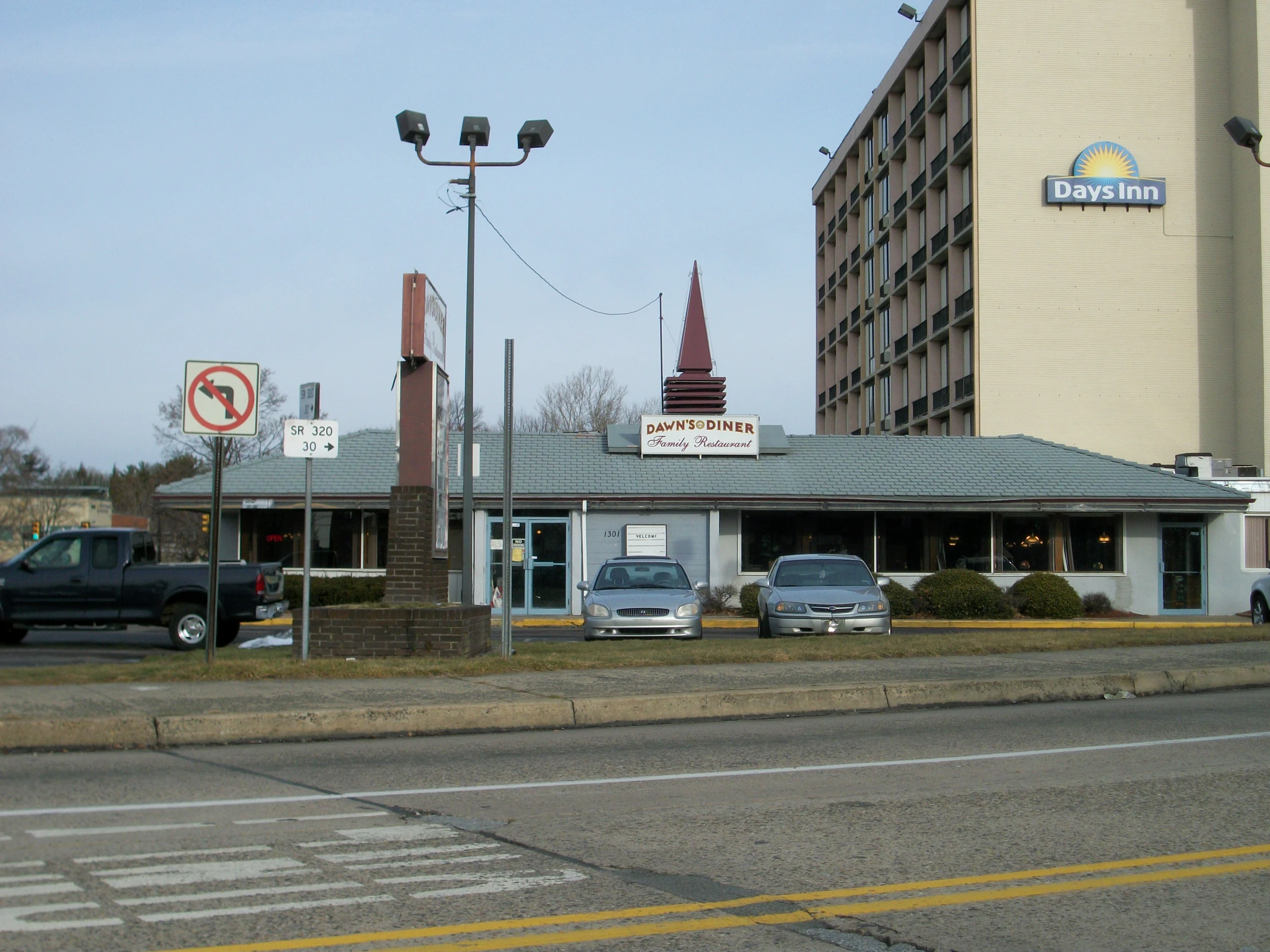 the motel is situated between two streets and some buildings