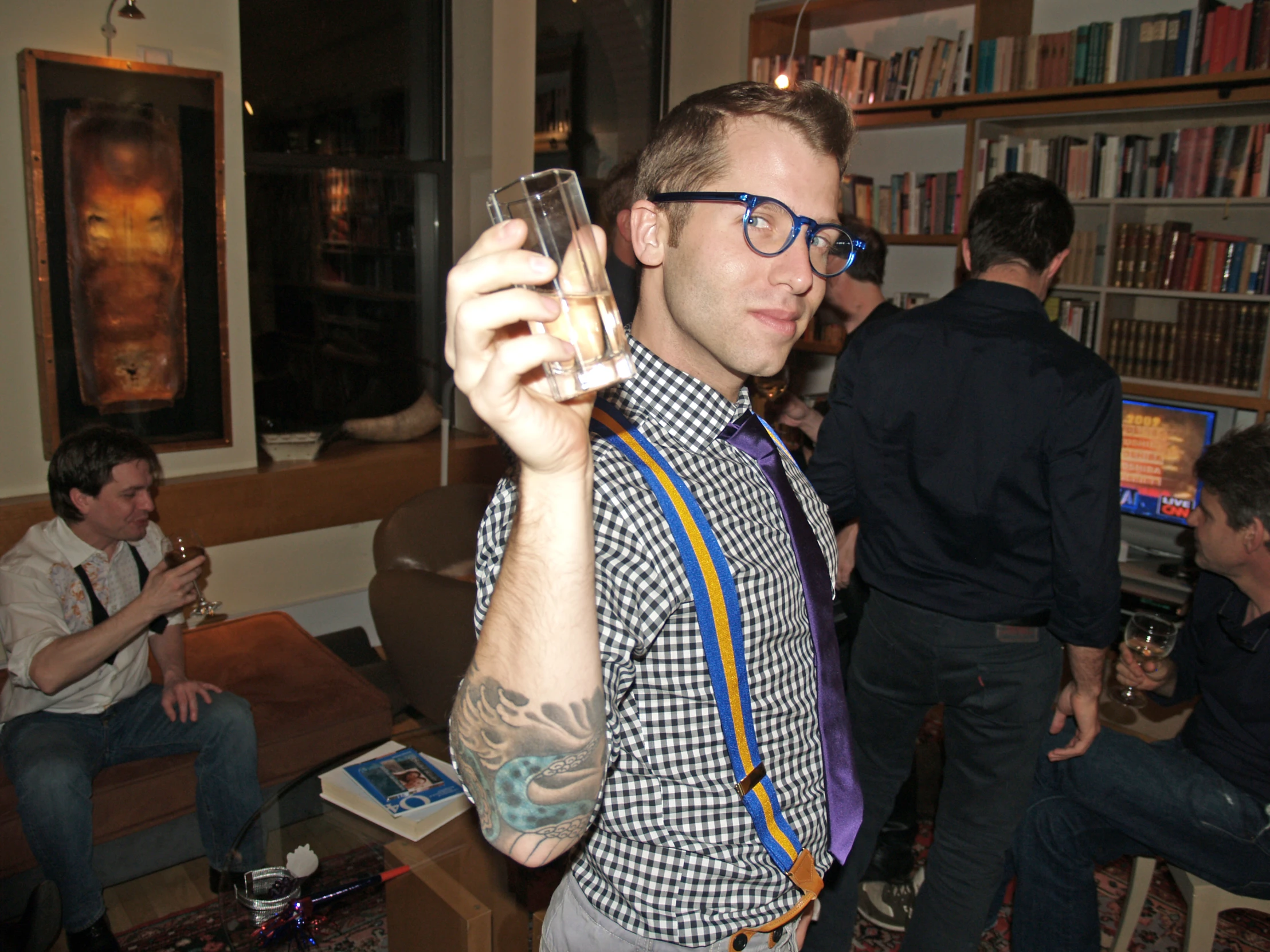 a man in glasses holding a wine glass