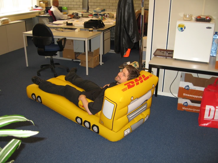 a young man sitting in a yellow truck bed