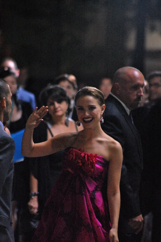 there is a smiling woman in a pink dress