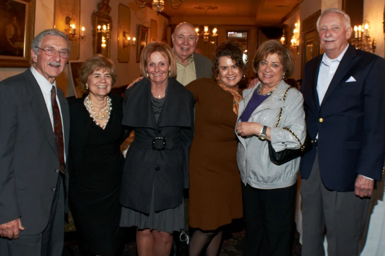 a large group of business people pose together