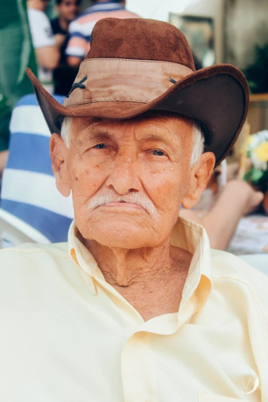 an older man wearing a cowboy hat