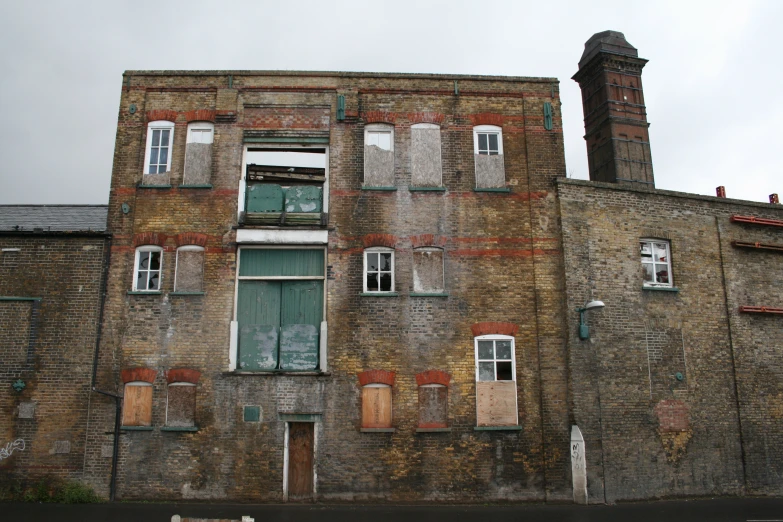 an old brick building with many windows and doors