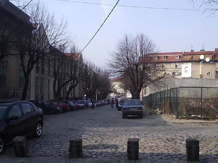 a city street that has cars parked along the road