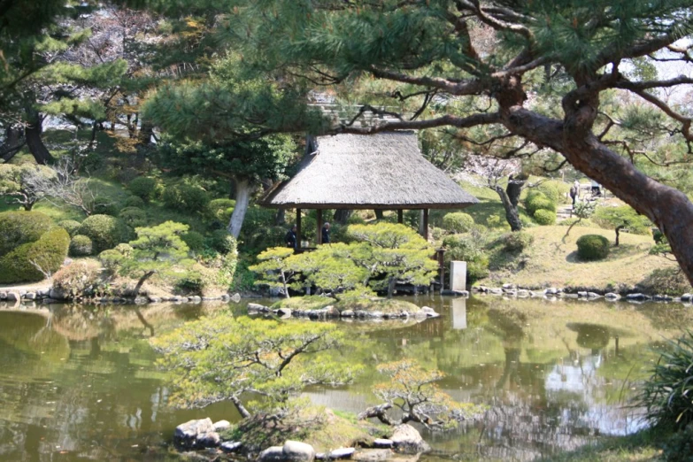 an outdoor gazebo is surrounded by trees and water