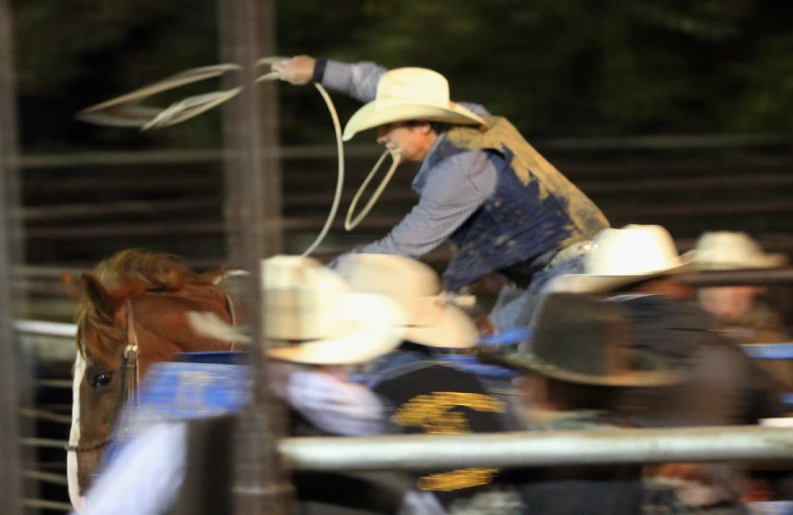 a man riding on the back of a brown horse