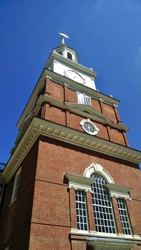 the large brick tower has a clock on it