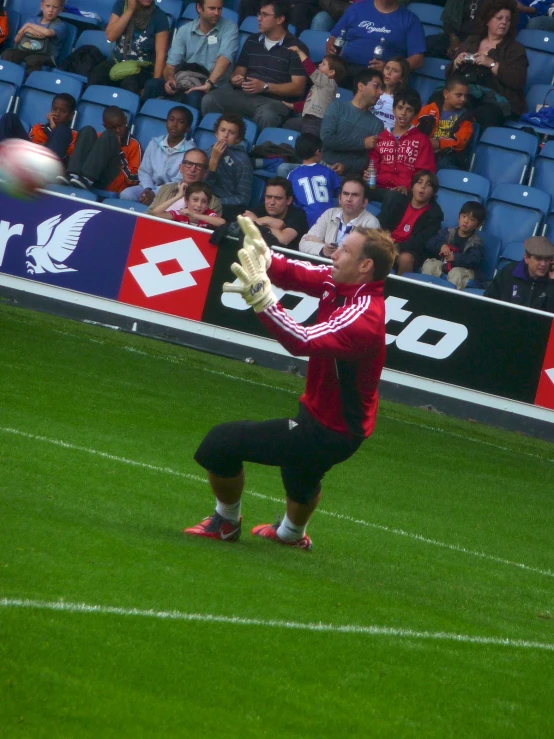 a man that is standing up in the grass with a soccer ball