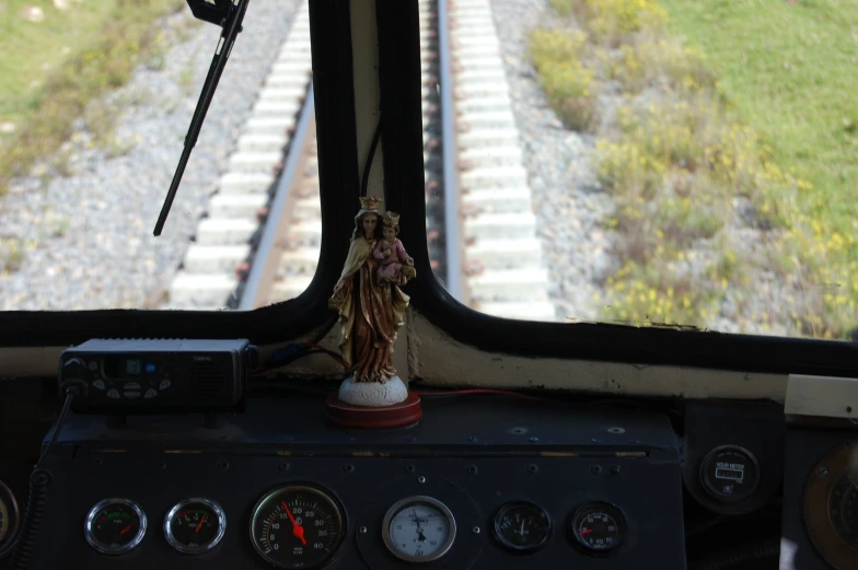 an empty train deck with gauges, clock, and statue