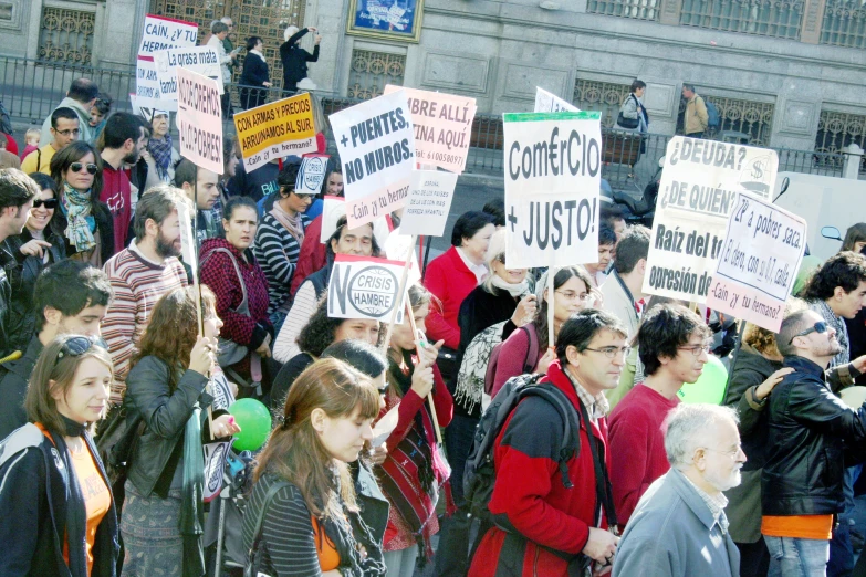 a group of people holding up signs at a protest