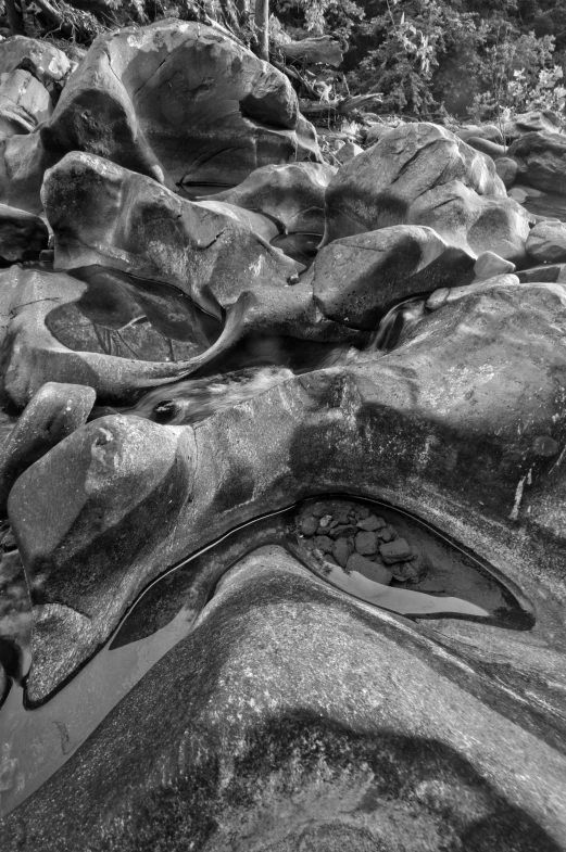 rocks with water in them near a river