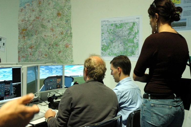 a group of people looking at computer screens