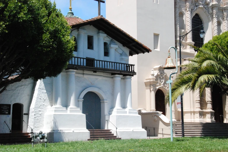 a large church sitting on top of a lush green field