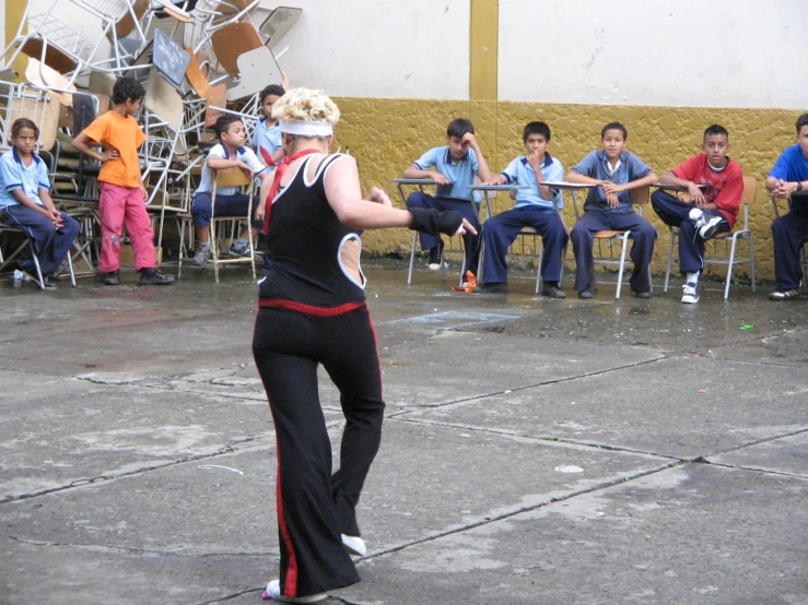 a woman with some fans watching her in the background