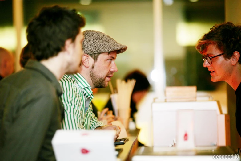 some men that are sitting at a table