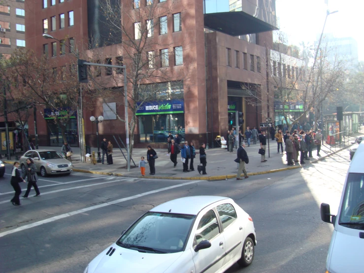 a group of people walking across the street