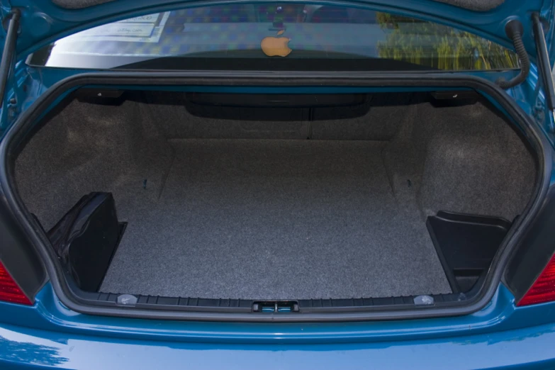 a car trunk has both the back seats folded open