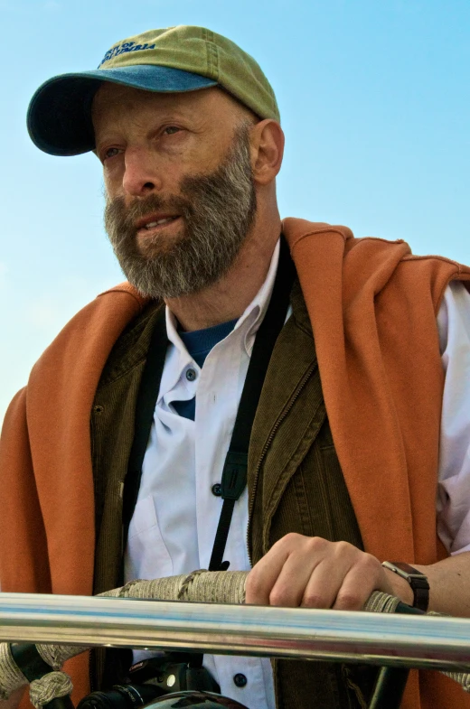 an older man wearing a hat with no hair