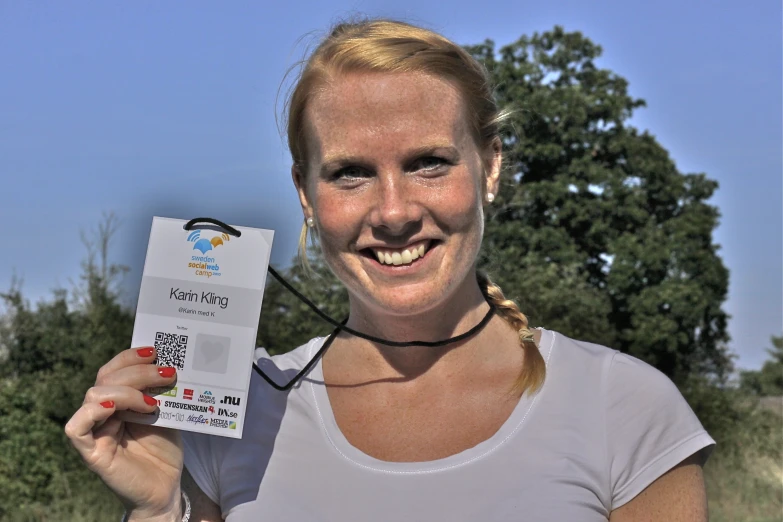 a woman holding up an award for her business