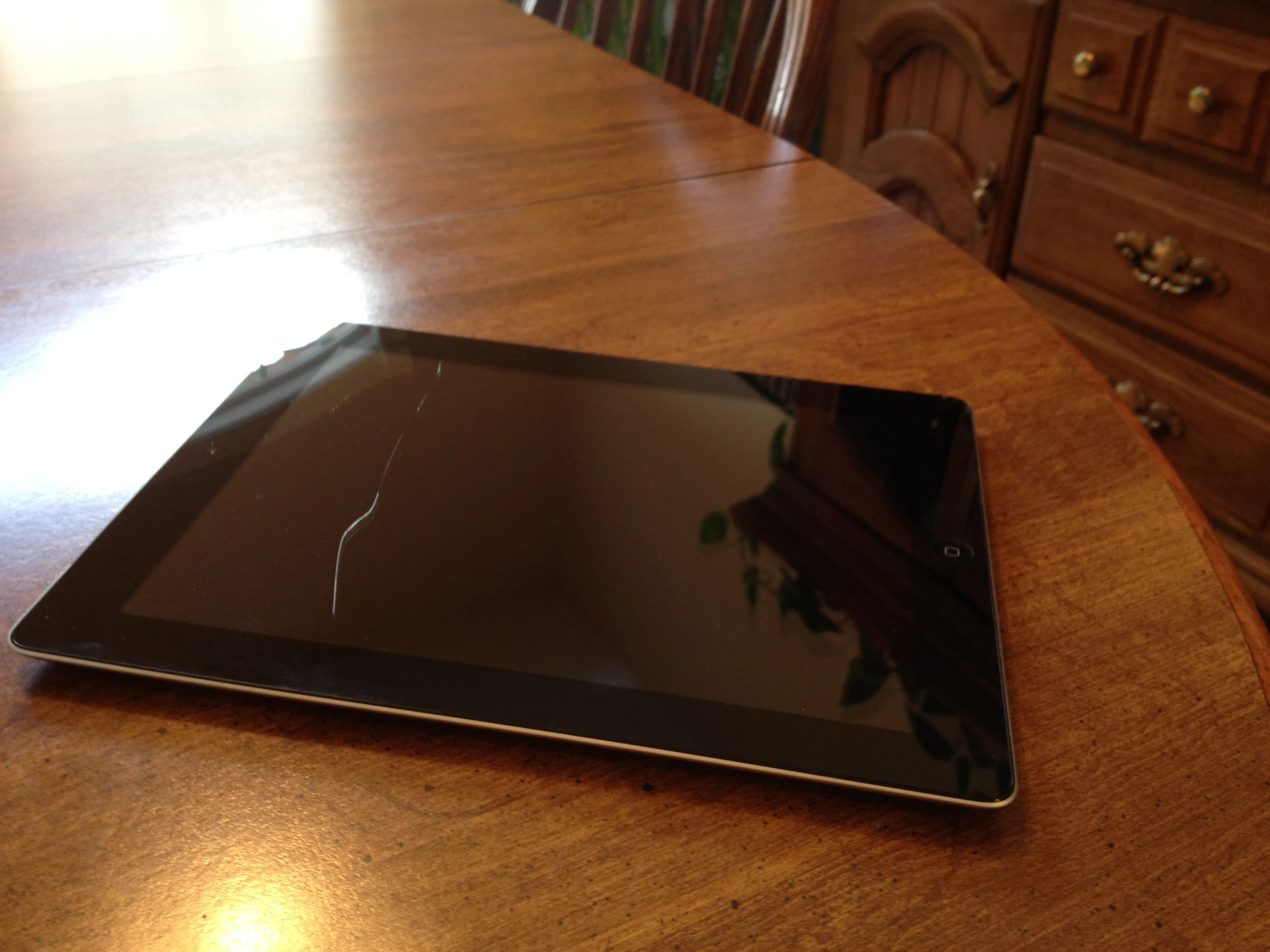 an open tablet sitting on a wooden table