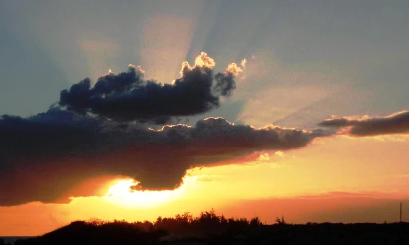 the sun peeking out from behind clouds