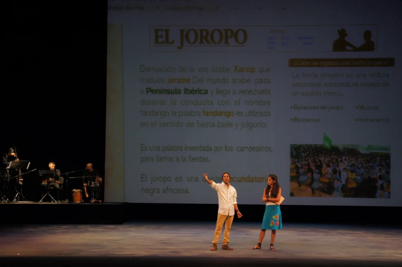 a woman standing in front of a person on a stage