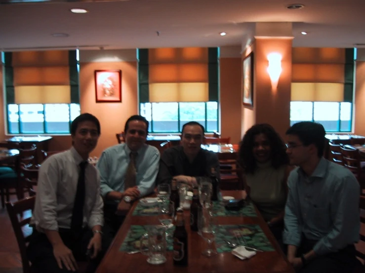 five friends pose at the bar for a po