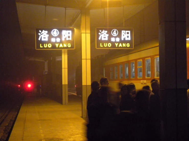 a group of people waiting at a train station