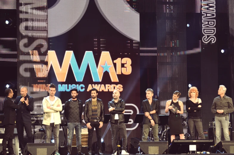 a group of men standing on a stage with award