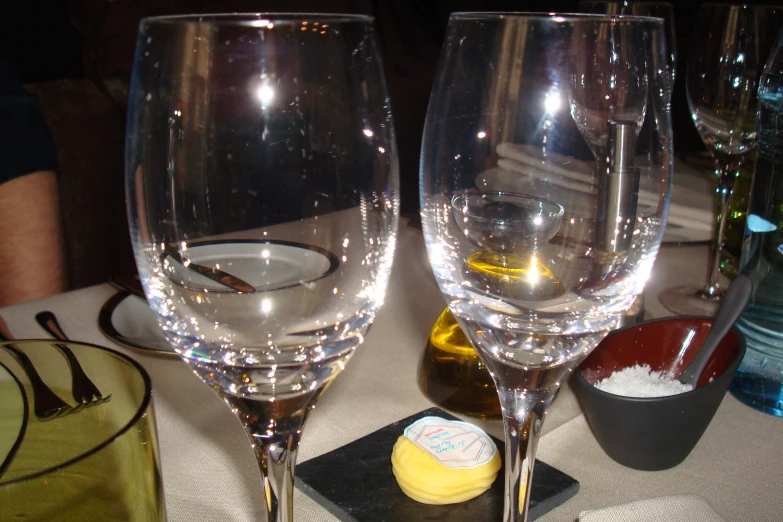 two wine glasses sitting next to each other on a table