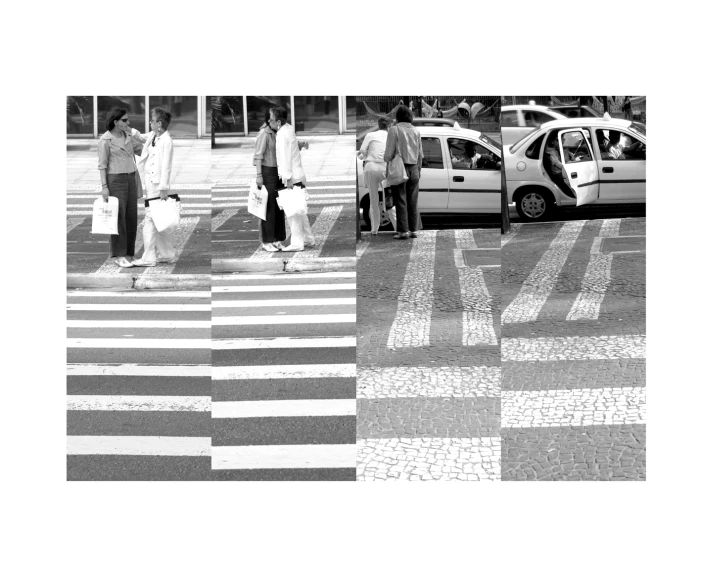 two people walking in the cross walk while a car is parked