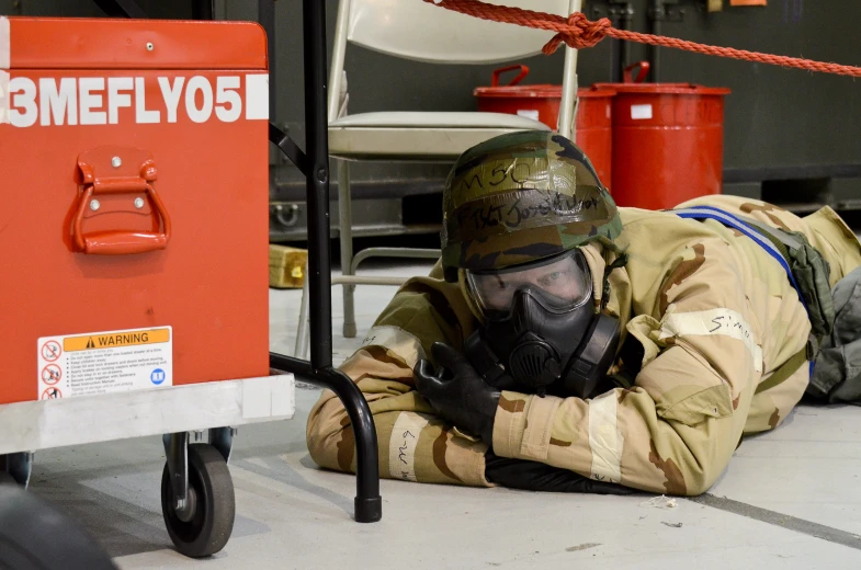 a man in a gas mask laying on the ground