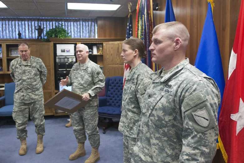 some military men and women in their uniforms and flags