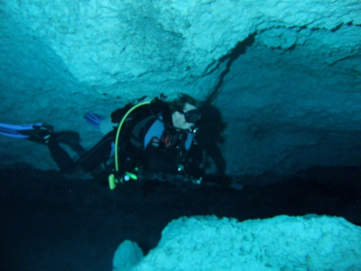 scuba diving with equipment at night in a cave