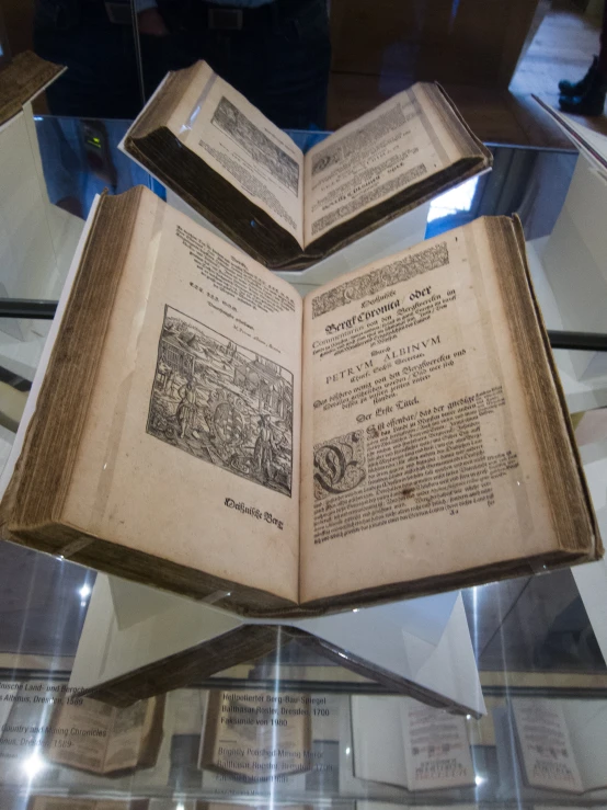 open old book on glass table top in display case