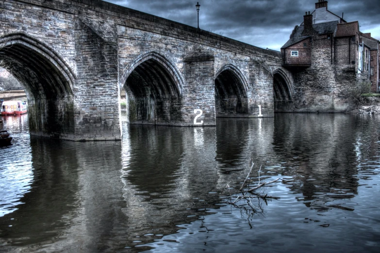 a view of the water under an old stone bridge