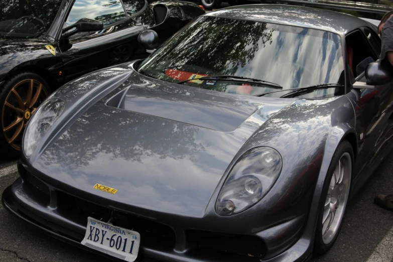 a grey sports car parked on the road