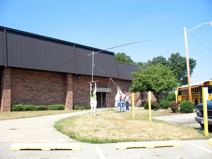 a group of people standing in front of a school building