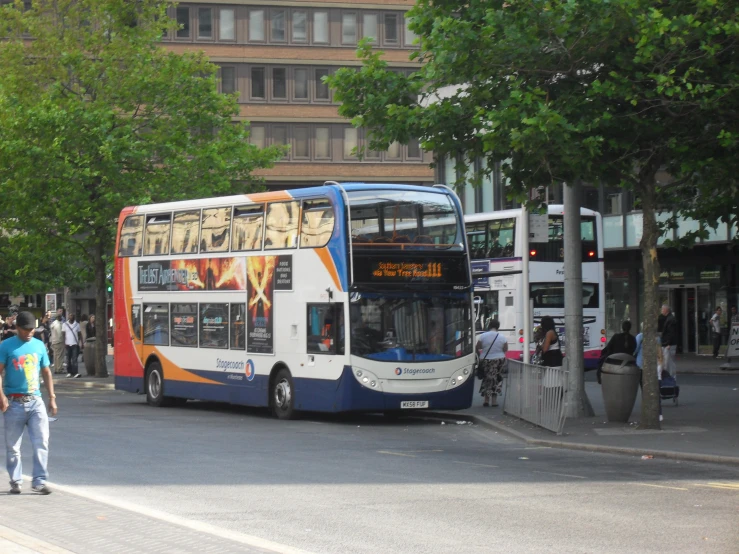 a double decker bus parked at a bus stop