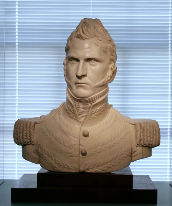 a clay statue of a man wearing a coat